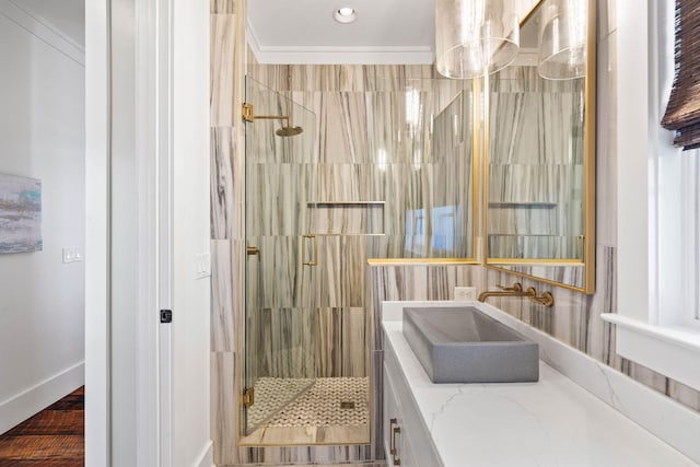 bathroom featuring vanity, ornamental molding, and walk in shower