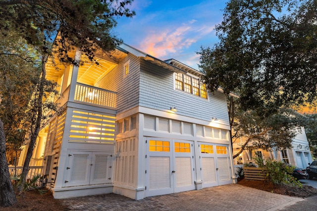 view of front of property featuring a balcony and french doors