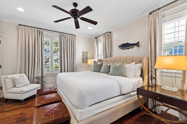 bedroom with crown molding, dark wood-type flooring, and ceiling fan