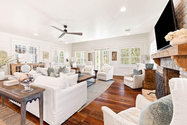 living room featuring ceiling fan and dark hardwood / wood-style floors