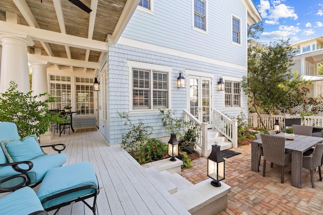 wooden terrace with an outdoor living space