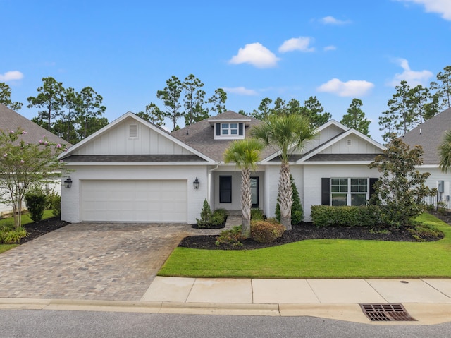 view of front of home with a garage and a front lawn