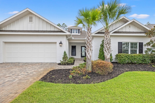 view of front of property featuring a garage and a front lawn