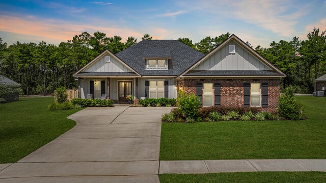 view of front of house with a yard and covered porch