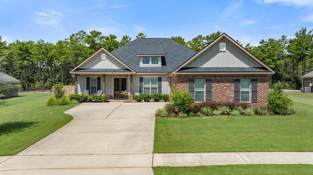 craftsman house with brick siding, board and batten siding, a front lawn, and roof with shingles