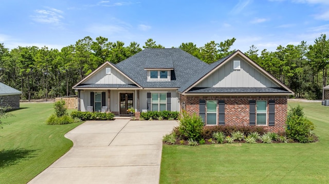 craftsman house featuring brick siding, board and batten siding, and a front lawn