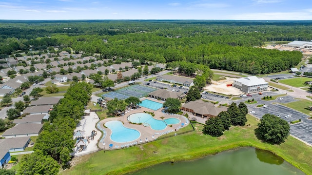 aerial view featuring a water view and a wooded view