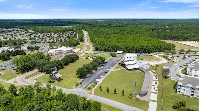 birds eye view of property featuring a forest view