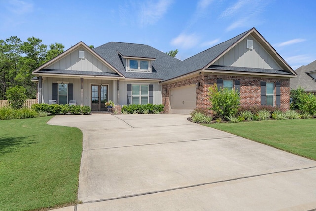 craftsman-style house with brick siding, a front lawn, concrete driveway, a garage, and board and batten siding