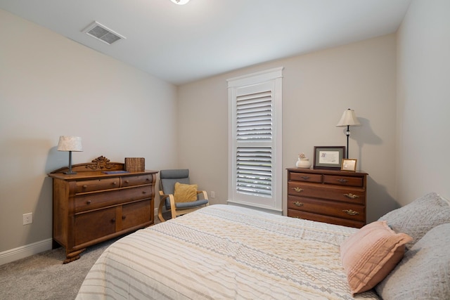 bedroom with carpet, visible vents, and baseboards