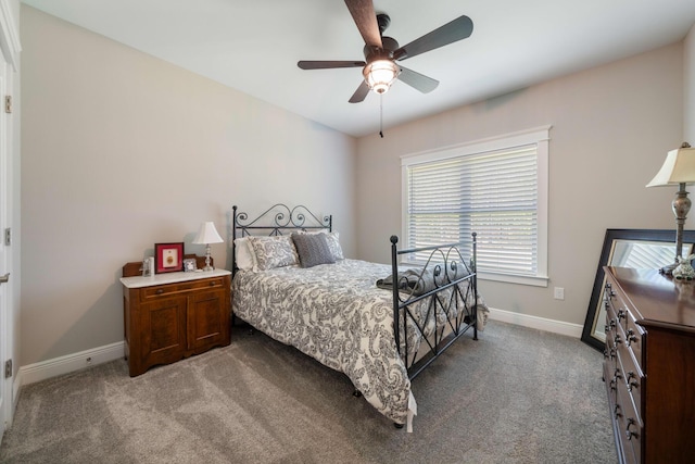 carpeted bedroom featuring baseboards and a ceiling fan