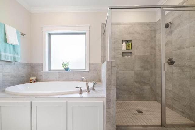 bathroom featuring a shower stall, crown molding, and a garden tub