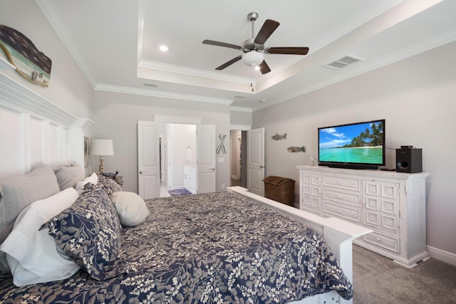 carpeted bedroom with visible vents, ornamental molding, baseboards, a raised ceiling, and ceiling fan