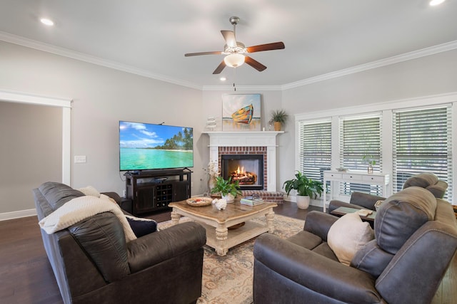 living area with baseboards, a brick fireplace, wood finished floors, and crown molding