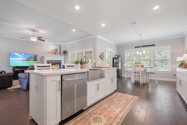 kitchen featuring open floor plan, dark wood-style flooring, light countertops, and stainless steel dishwasher