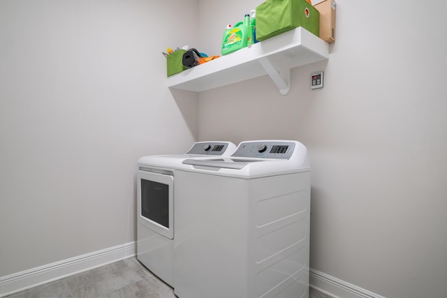 laundry area with washing machine and clothes dryer, laundry area, and baseboards