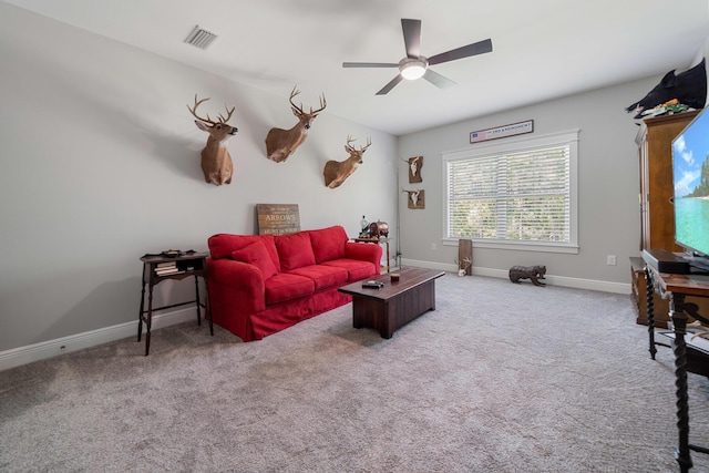 carpeted living area with a ceiling fan, visible vents, and baseboards