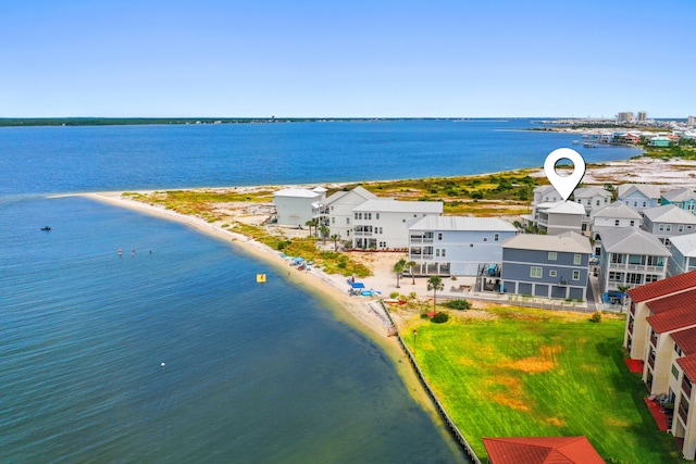 drone / aerial view with a beach view and a water view