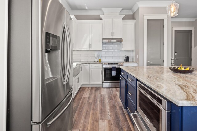 kitchen featuring hanging light fixtures, stainless steel appliances, blue cabinetry, and white cabinetry