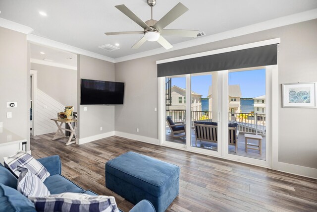 living room featuring crown molding, ceiling fan, and wood-type flooring