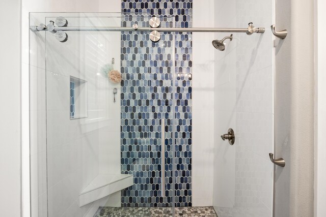 bathroom with a tile shower