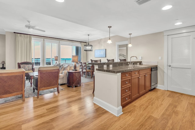 kitchen with stainless steel dishwasher, light hardwood / wood-style flooring, decorative light fixtures, and ceiling fan