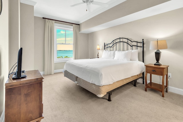 bedroom featuring light colored carpet, crown molding, and ceiling fan