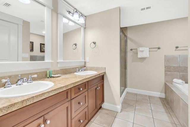 bathroom featuring tile patterned flooring, independent shower and bath, and vanity