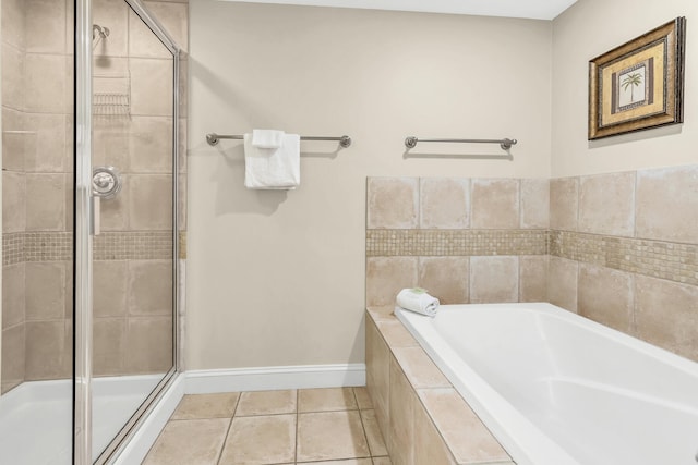 bathroom with tile patterned flooring and shower with separate bathtub