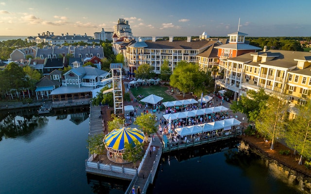 aerial view at dusk featuring a water view