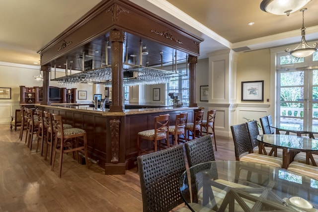 bar featuring hardwood / wood-style flooring and crown molding