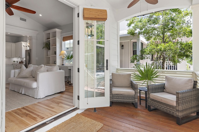 sunroom with ceiling fan and lofted ceiling