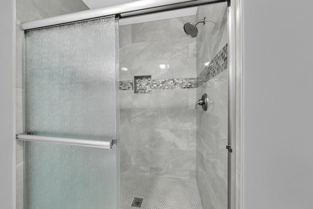 bathroom featuring a shower with shower door