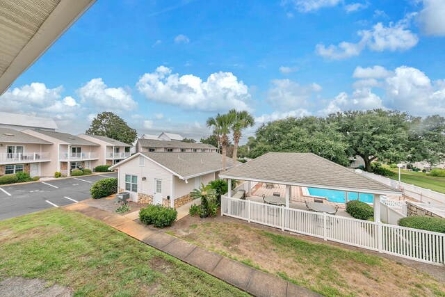 exterior space featuring a balcony and a lawn