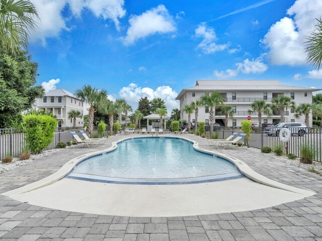 community pool featuring a patio and fence