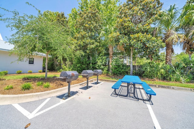 view of community featuring outdoor dining space and a patio