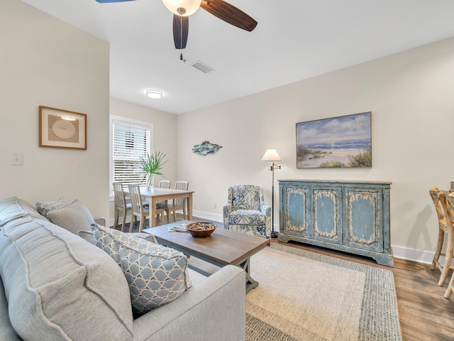 living room with hardwood / wood-style floors and ceiling fan