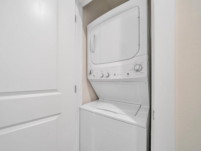 laundry area with laundry area and stacked washer / dryer