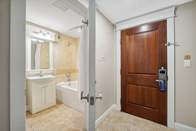 bathroom with tile patterned flooring, vanity, and shower / bath combination with curtain