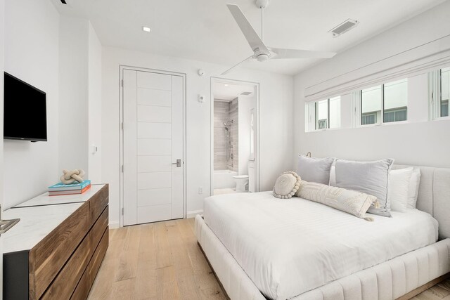 bedroom with ceiling fan, a closet, ensuite bath, and light hardwood / wood-style floors