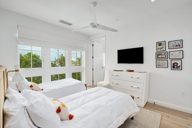 bedroom with light wood-type flooring and ceiling fan