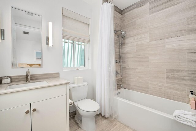 full bathroom featuring shower / tub combo, vanity, and toilet