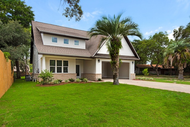 view of front of property featuring central AC, a garage, and a front lawn