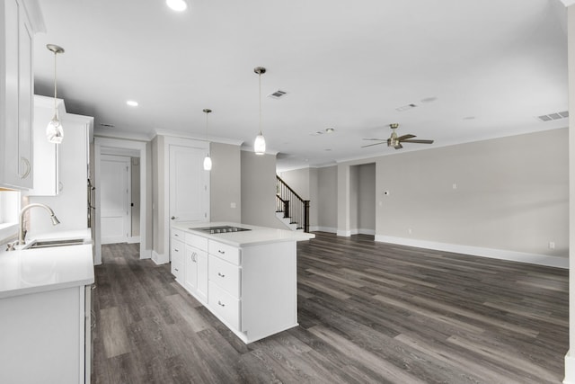 kitchen with white cabinets, pendant lighting, dark hardwood / wood-style flooring, and sink