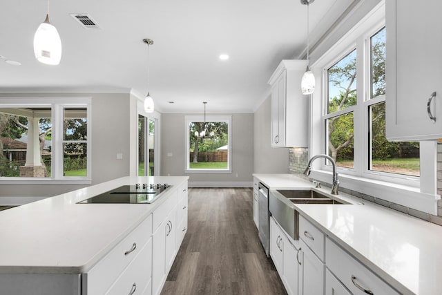 kitchen with a kitchen island, hanging light fixtures, sink, white cabinetry, and black electric cooktop