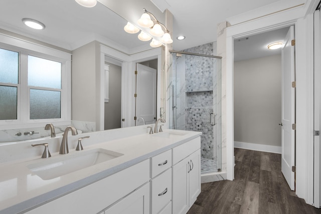 bathroom with a shower with door, vanity, and hardwood / wood-style floors