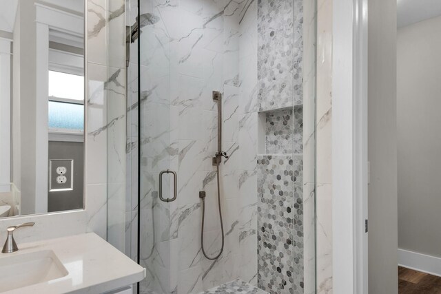 bathroom with vanity, wood-type flooring, and an enclosed shower