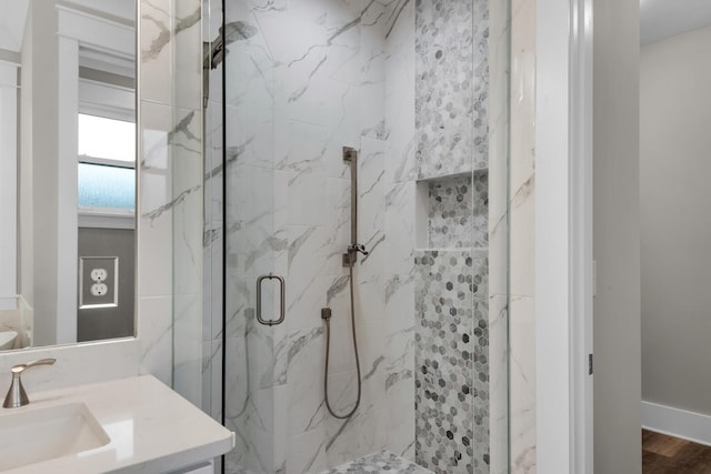 601 Third Ave, Destin, FL 32541 - bathroom featuring a marble finish shower, wood finished floors, and vanity