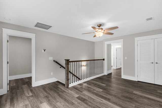 unfurnished room with ceiling fan and dark hardwood / wood-style floors