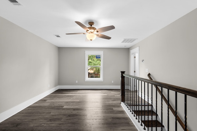 unfurnished room featuring ceiling fan and dark hardwood / wood-style floors